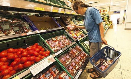 Woman shopping in Tesco supermarket, UK